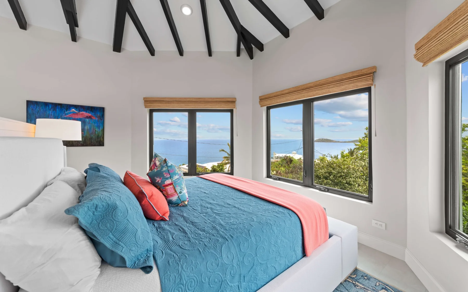 Ocean-view bedroom with teal bedding