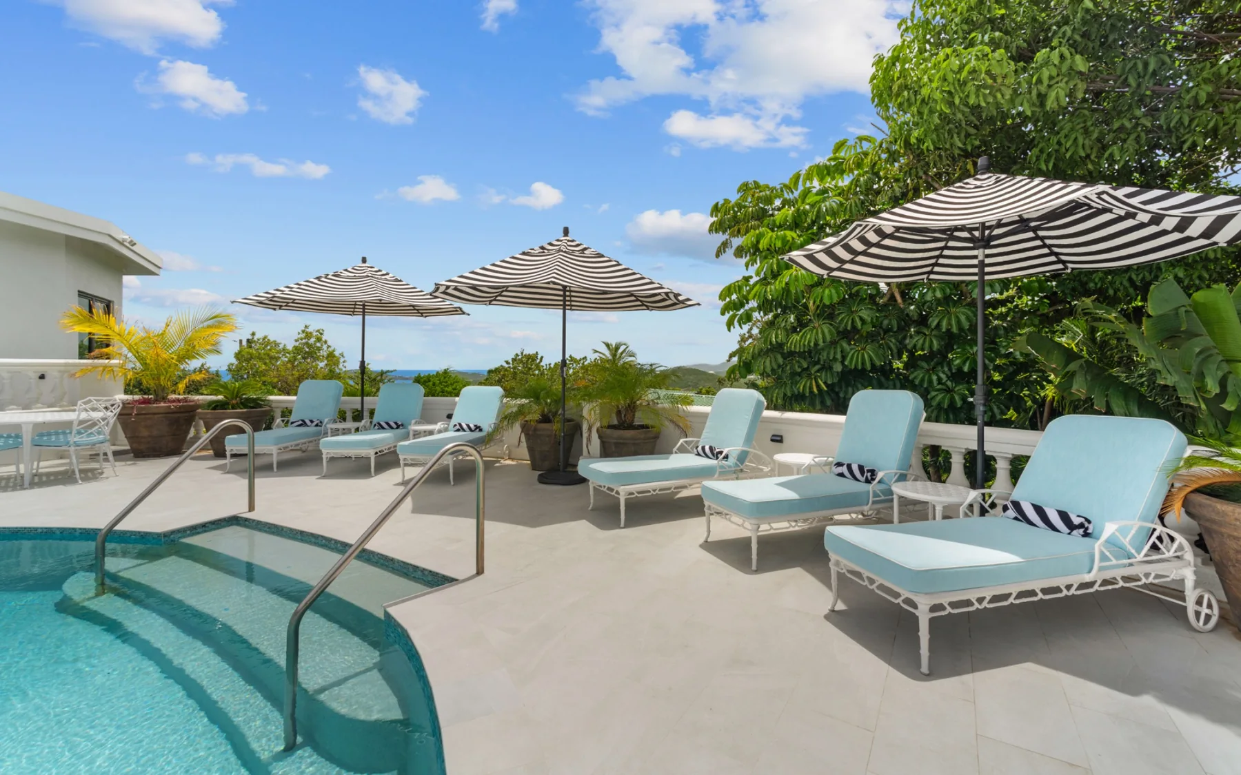 Pool steps, loungers, and umbrellas